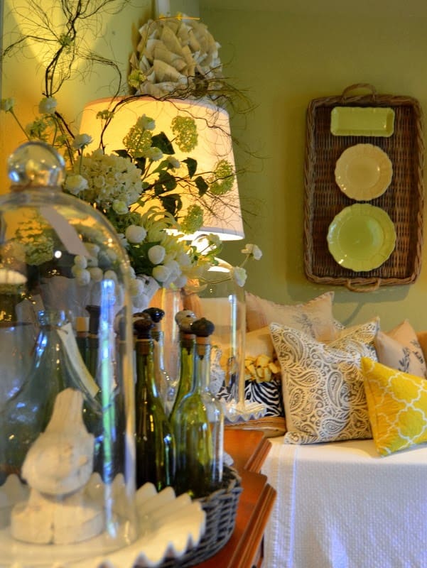 Glass cloches on a side table filled with spring decor.