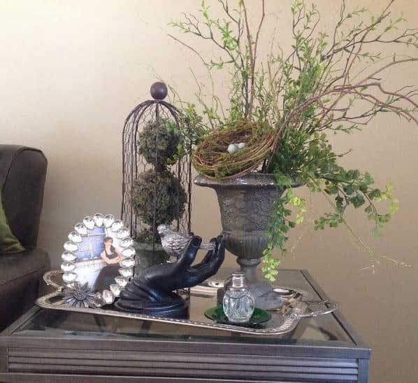 A silver tray with a perfume bottle and picture.