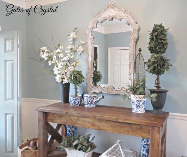 A wooden side table with blue and white ceramic pt