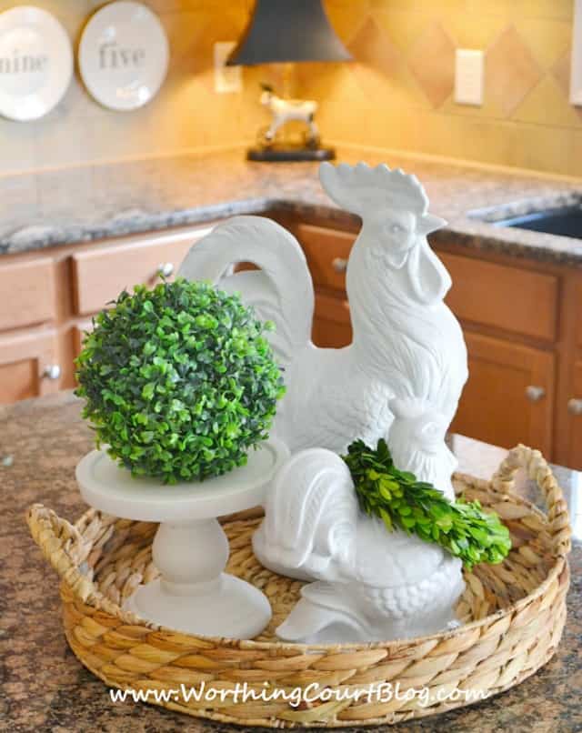 A porcelain rooster with greenery.