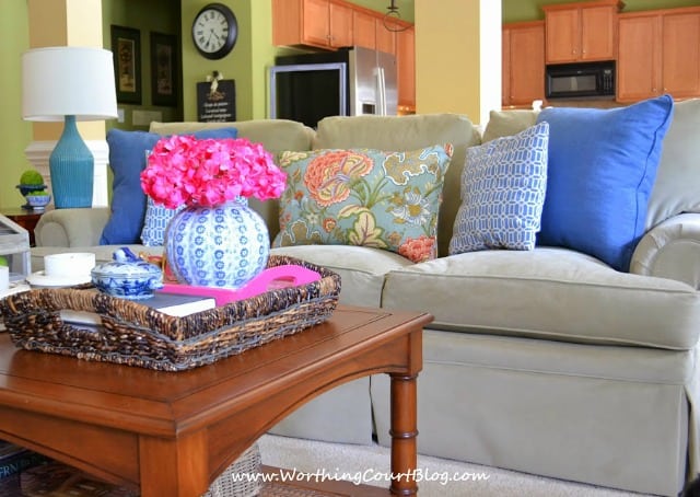 There are pink flowers in a vase on the coffee table.