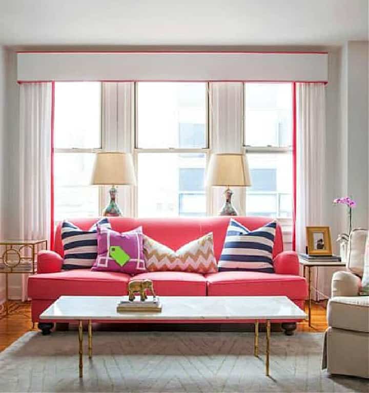 pink couch in front of white curtains embellished with grosgrain ribbon