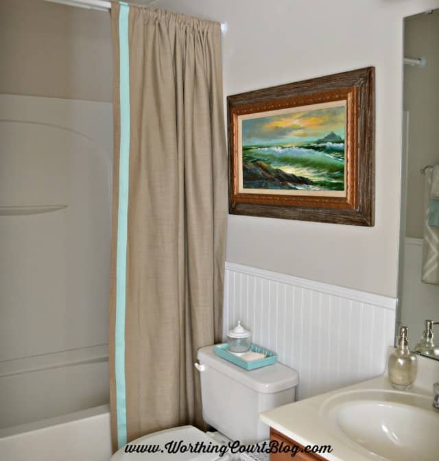 A neutral and aqua small bathroom with a beachy vibe.