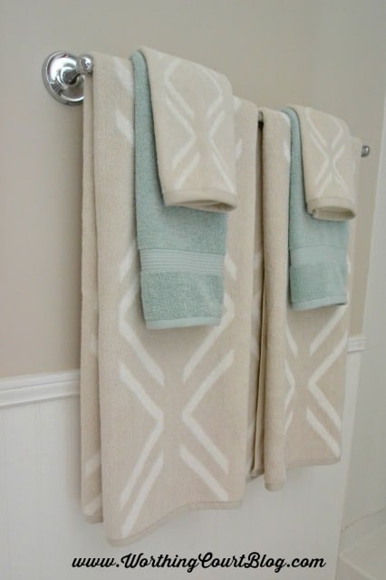 Layer towels of different patterns and colors together in a bathroom.