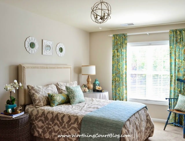 The guest bedroom with neutral and aqua decor.