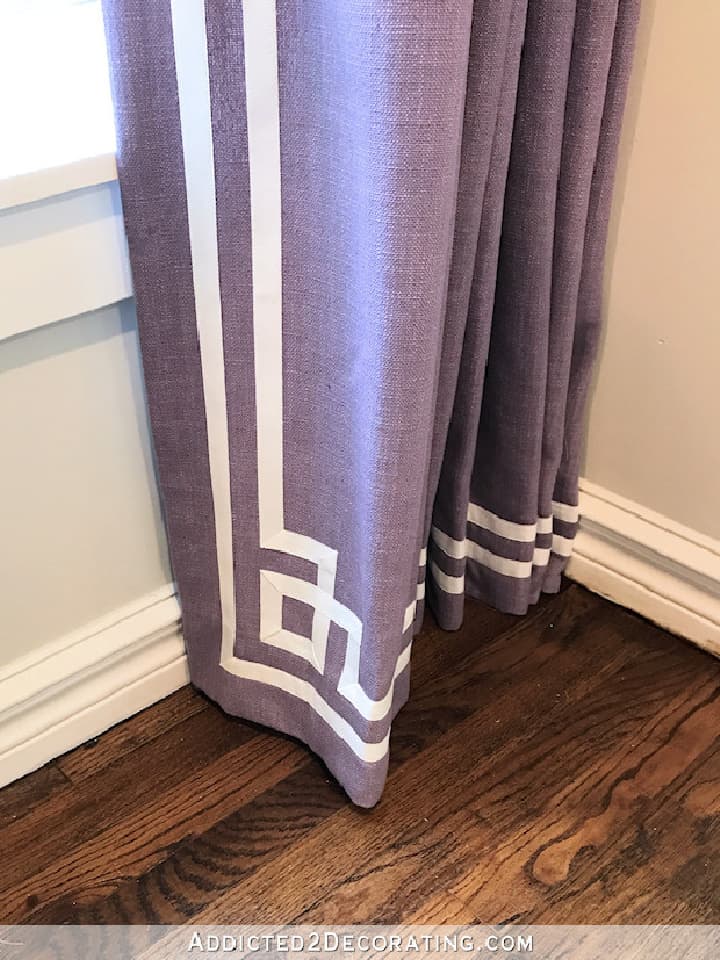 bottom of purple drapery panel with Greek key white ribbon trim