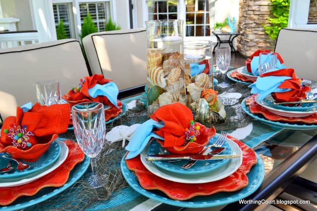 Outdoor dining at it's finest at a beautiful turquoise and coral tablescape.