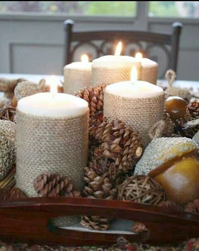 Bring in some warmth and texture for fall using burlap wrapped candles and pinecones to create an easy centerpiece.