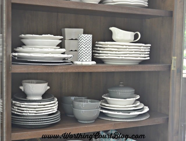 Plates and accessories stacked and displayed in a cabinet in the kitchen