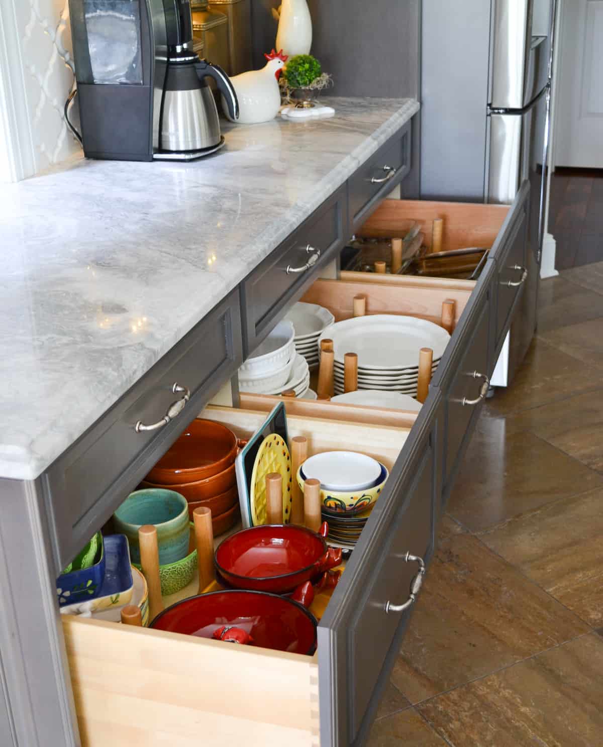 organized kitchen drawers filled with plates and platters