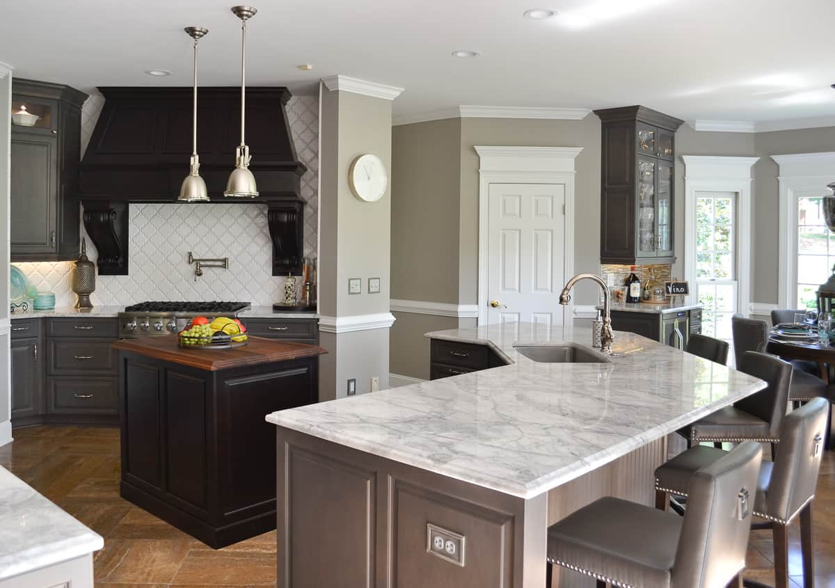 view of a kitchen with gray custom cabinets and marble-look quartz counters