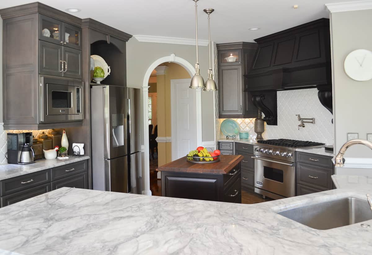 view of a kitchen with gray custom cabinets and marble-look quartz counters