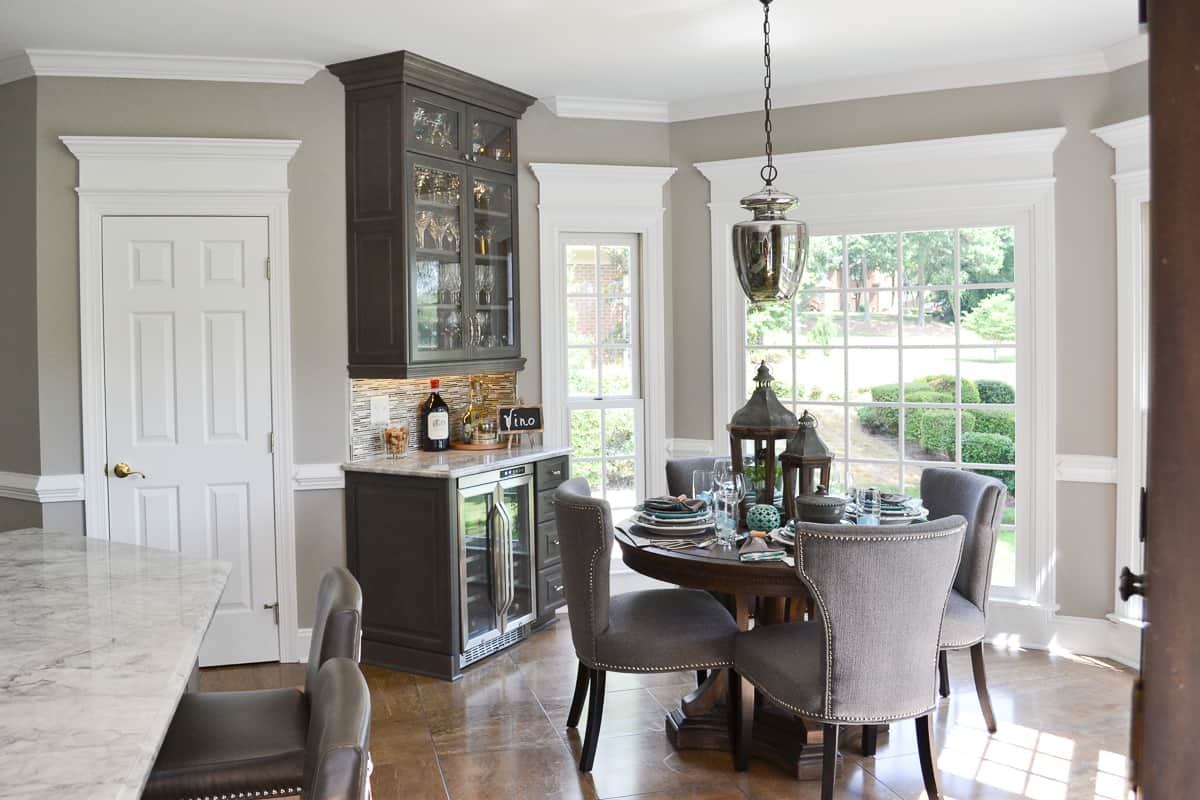 built-in wine bar in a kitchen breakfast nook besied the kitchen table