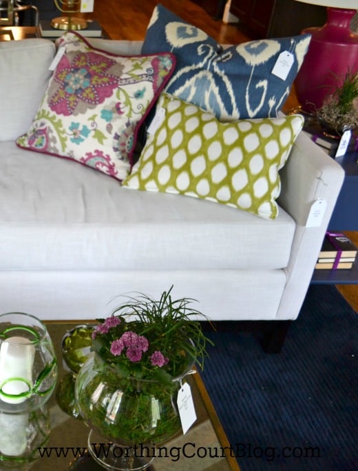 Colorful accent pillows on a white couch.