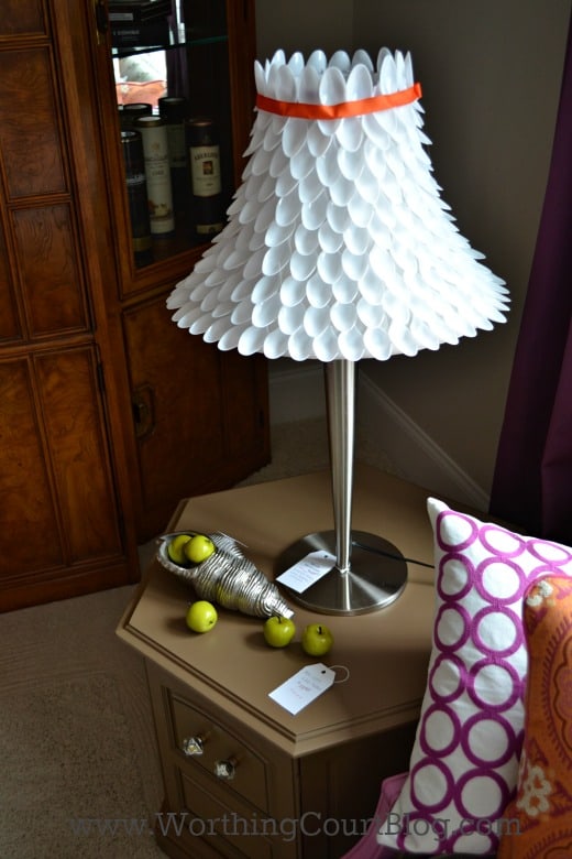 Cover a lampshade with plastic spoons.