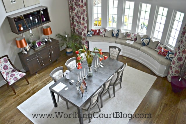 Large bay windows with a built in window seat full of pillows.