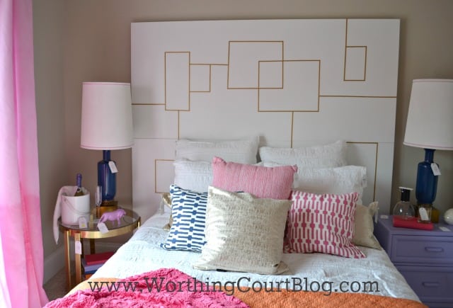 Headboard made of two doors, one stacked on the top of the other with small pieces of gold painted wood applied.