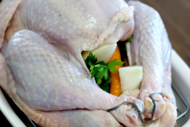 For a flavorful turkey, rub the turkey skin with butter and lemon juice and fill the chest cavity with celery tops, carrots, onions and fresh parsley.