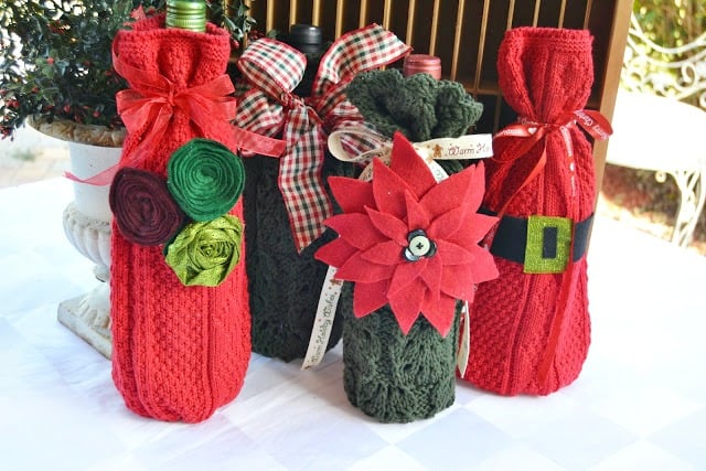 Red and green wine bottle cozies with floral details.