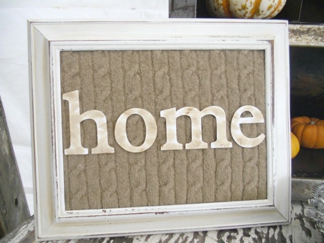 Add instant coziness to your home by using a piece of cutout sweater as a backing for letters in an old frame.