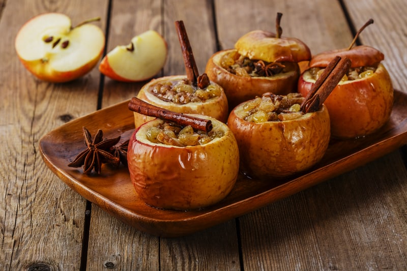 Easy and super yummy baked honeycrisp apples recipe with the baked apples on a wooden tray.