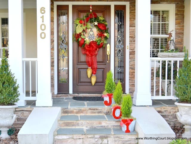 Planters on the porch which spell out JOY.