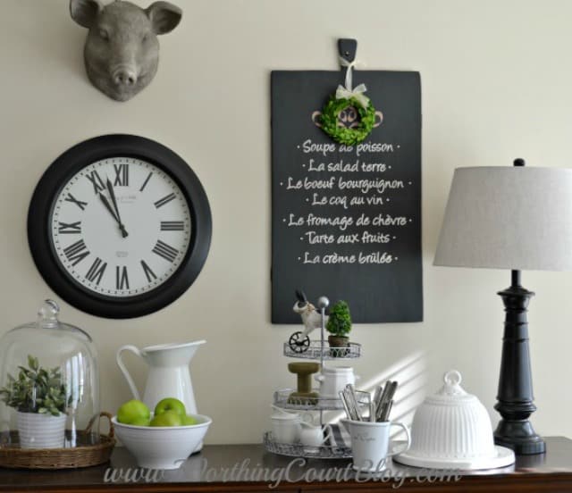 A clock is on the wall above the dresser.