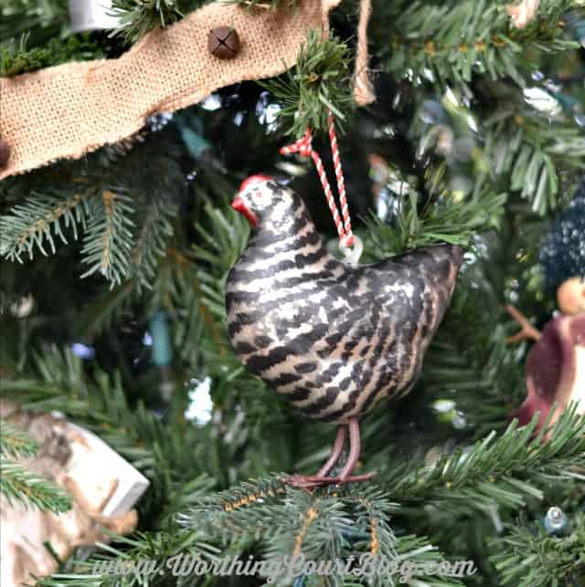 Farmhouse hen Christmas ornament hanging on the Christmas tree.