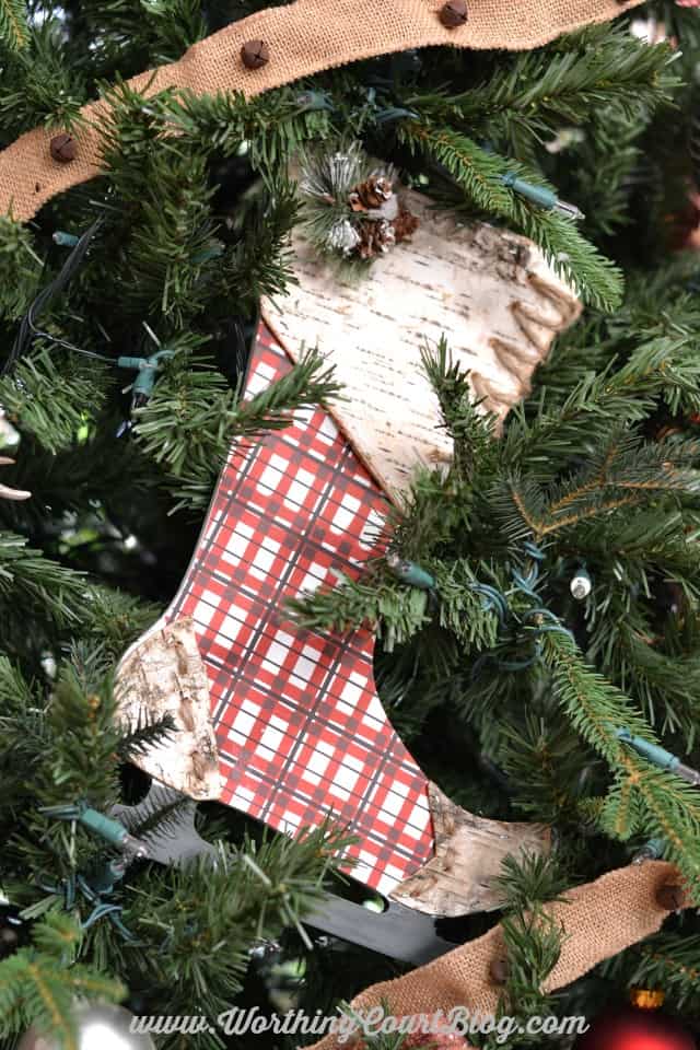 A plaid wooden stocking on the tree.