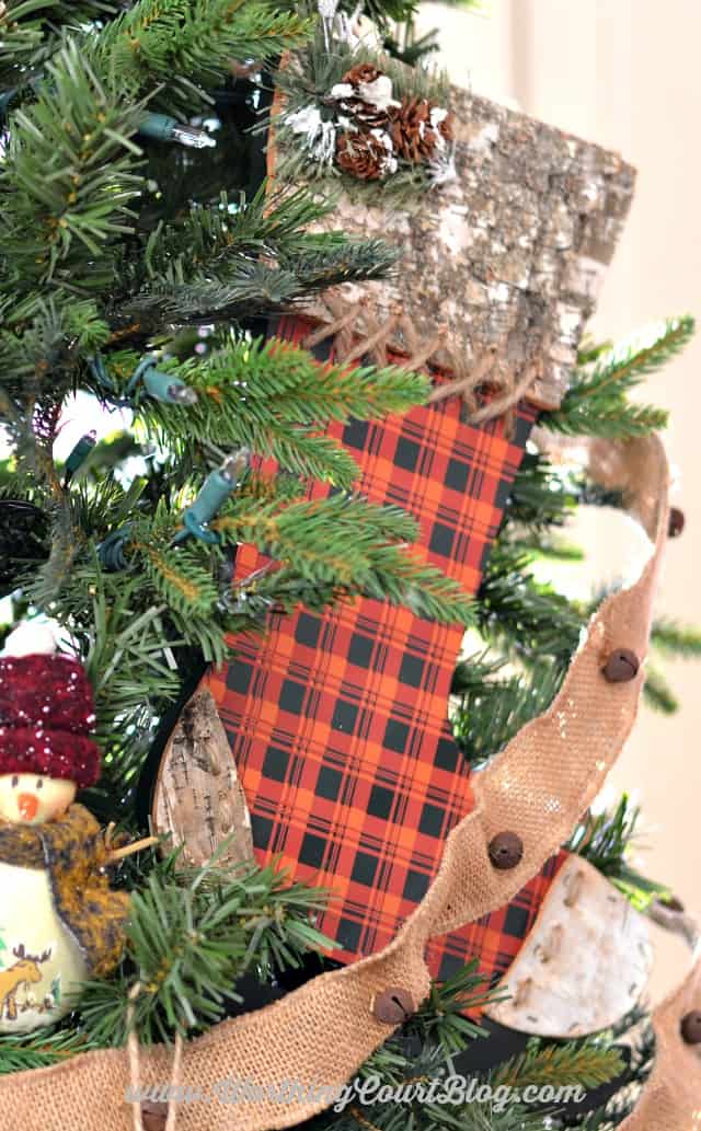 A second plaid wooden stocking on the Christmas tree.