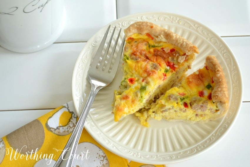 Breakfast casserole with eggs and sausage on a white plate.