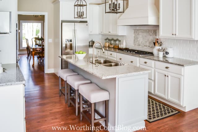 Wood and white barstools at the island.