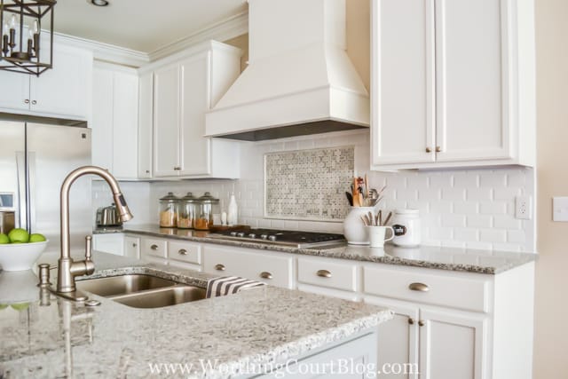 White cabinets and soft toned countertops in the kitchen.