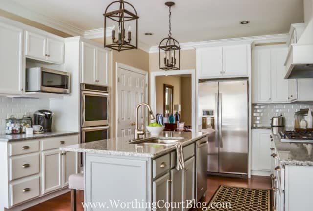 Bronze lights are above the kitchen island.