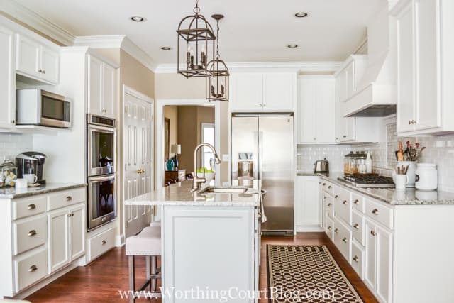 The white kitchen with stainless steel appliances.