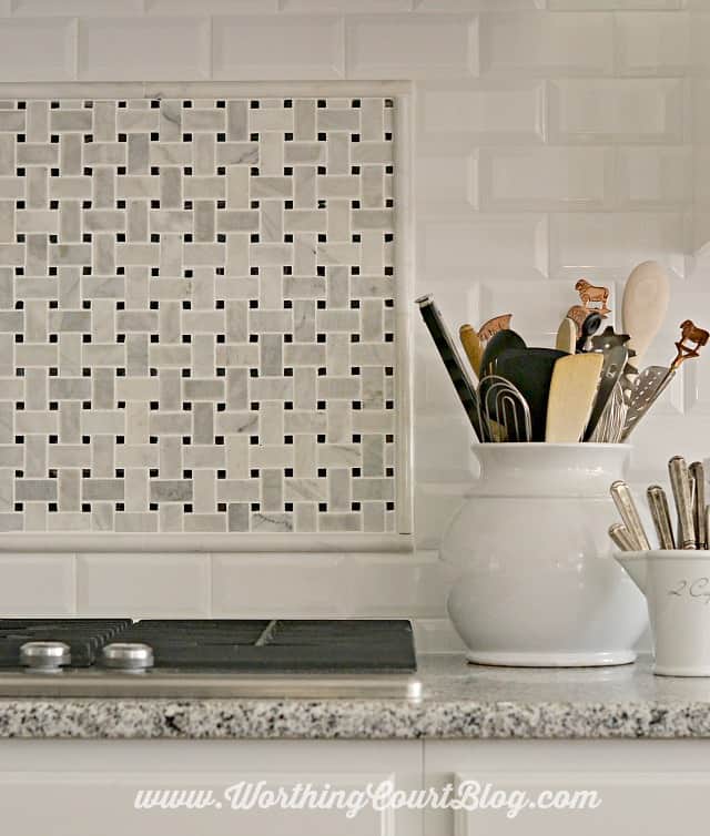 Kitchen backsplash using faceted subway tile and carrera marble.