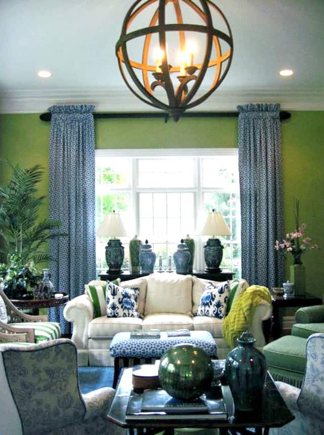 Green walls and blue decor in this living room.