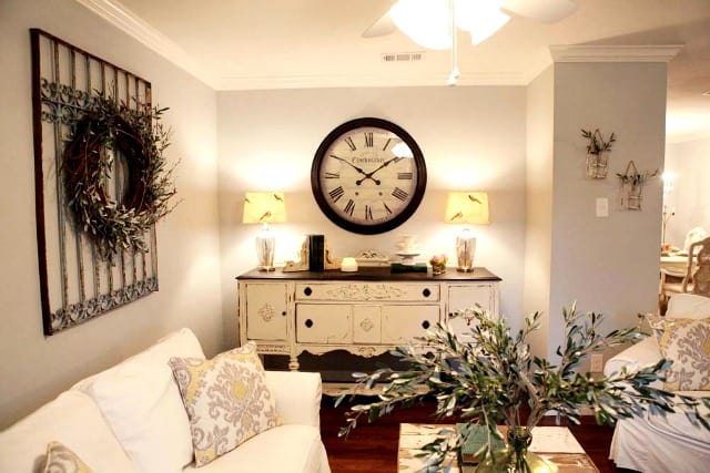 A rustic clock from Fixer Upper in the living room on the wall.