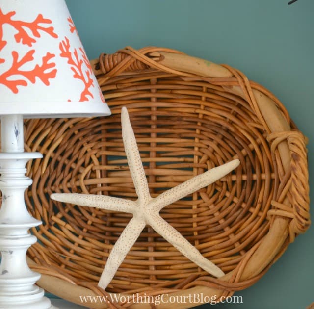 Add a starfish to a basket leaning against the back of a bookcase.