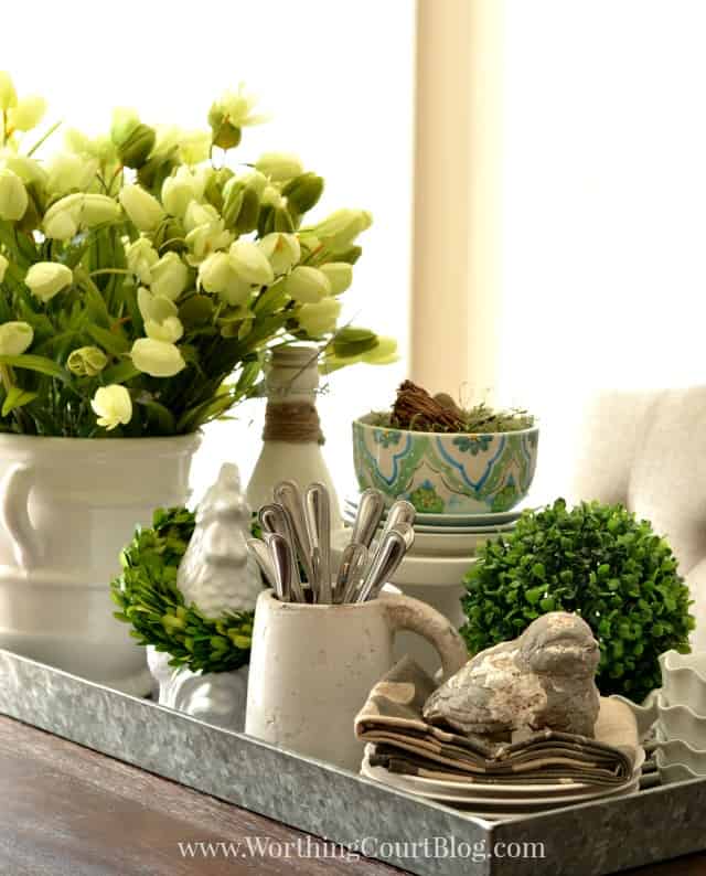 A galvanized steel tray filled with spring items.