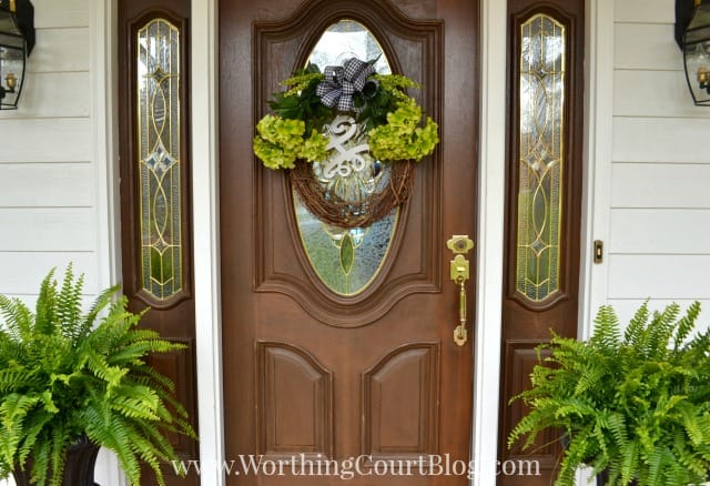 The front door of a house with a wreath on it.