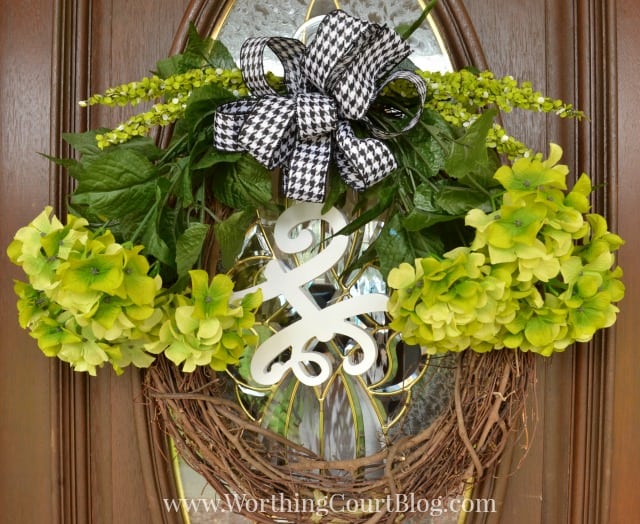 Lots of greenery and a black and white bow on the door.