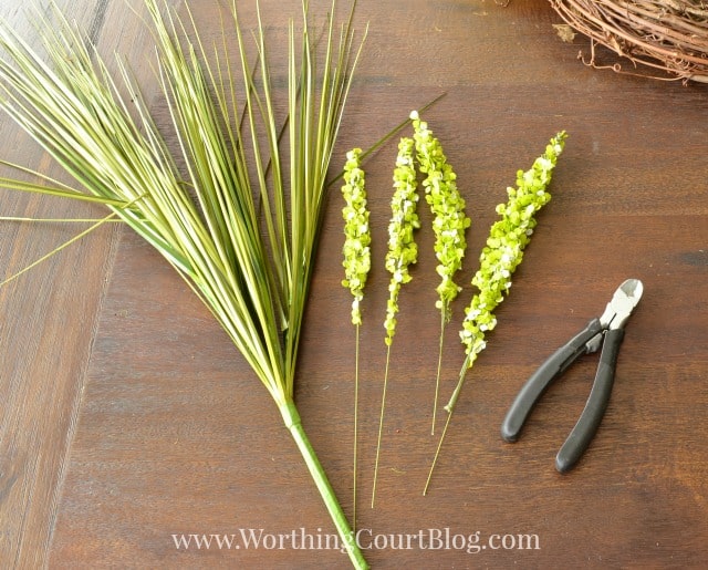 Wire cutters and greenery laid out for the wreath.