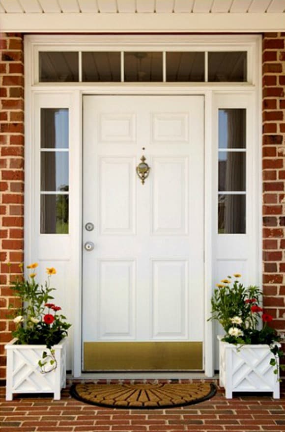 Simple planters and a fresh mat are all that's needed to appreciate the beauty of a pretty front door and sidelight arrangement