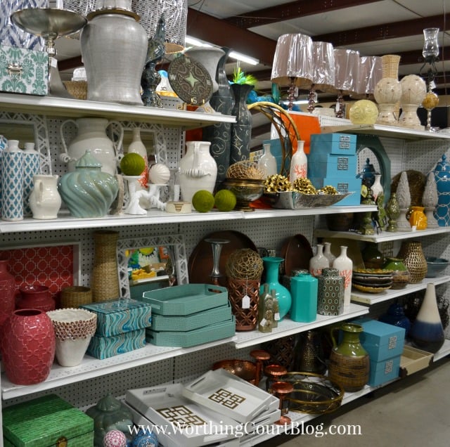 Lamps, pottery, vases and trays on a store shelf.