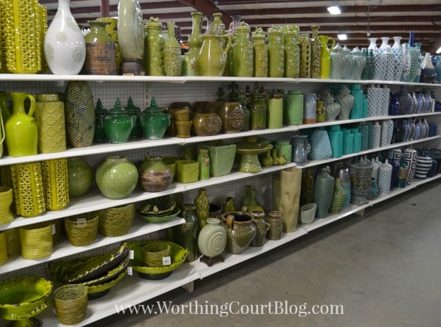 Green and yellowish pottery designs on a shelf.