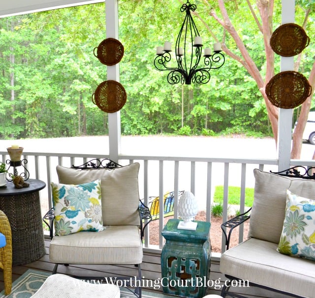 A wrought iron light fixture hangs on the porch.