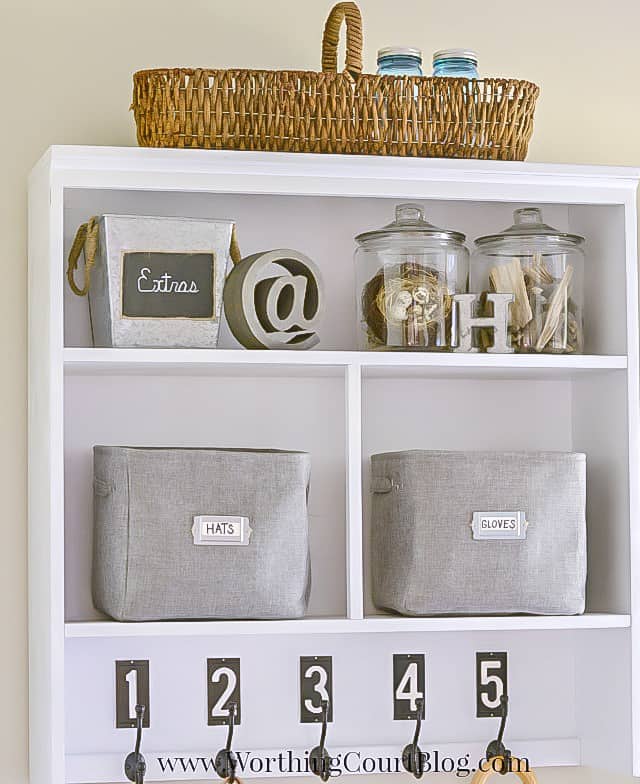 The shelving unit with baskets and numbers on it.