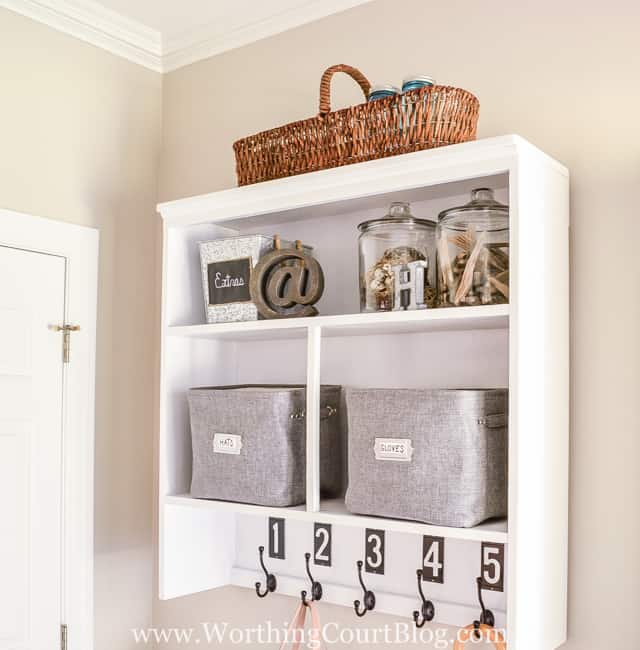 A rectangle wicker bag is on the top of the shelf.