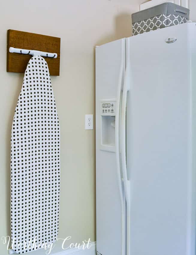 DIY ironing board hanger for the laundry room.